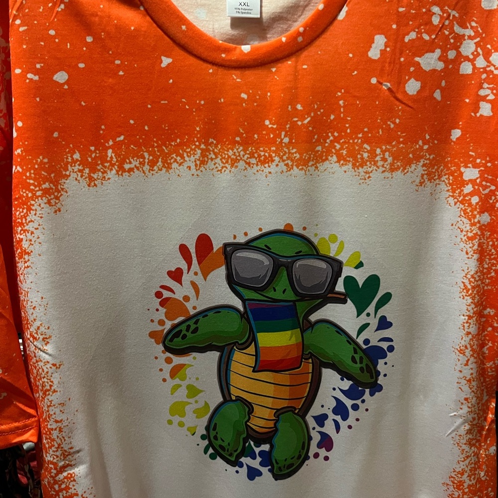 Custom T-shirts bleached, one orange and one purple 2X in women’s size.